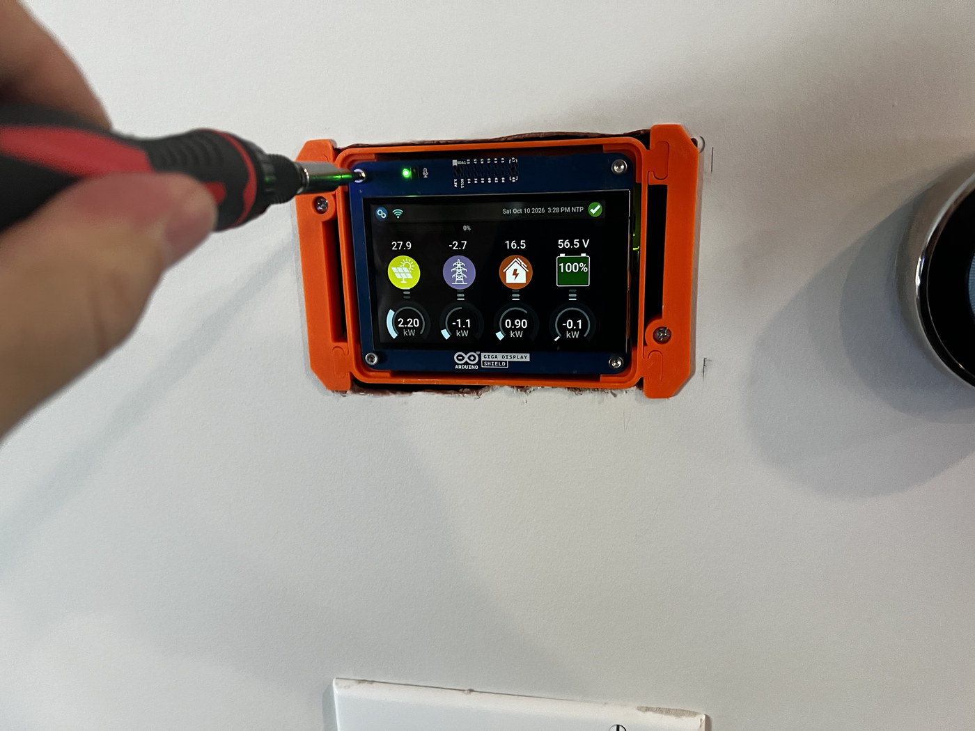 Securing the Inverter View display in its wall-mounted enclosure